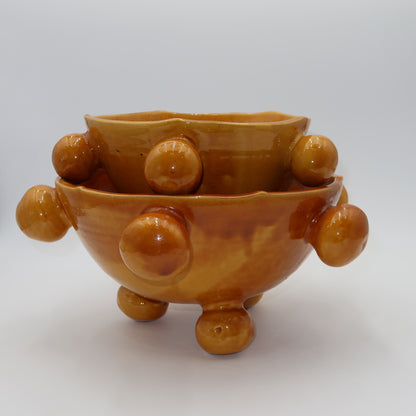 Ballo medium and large ceramic bowl, burnt yellow glaze, sculptural bobble details, ball feet, wavy rim