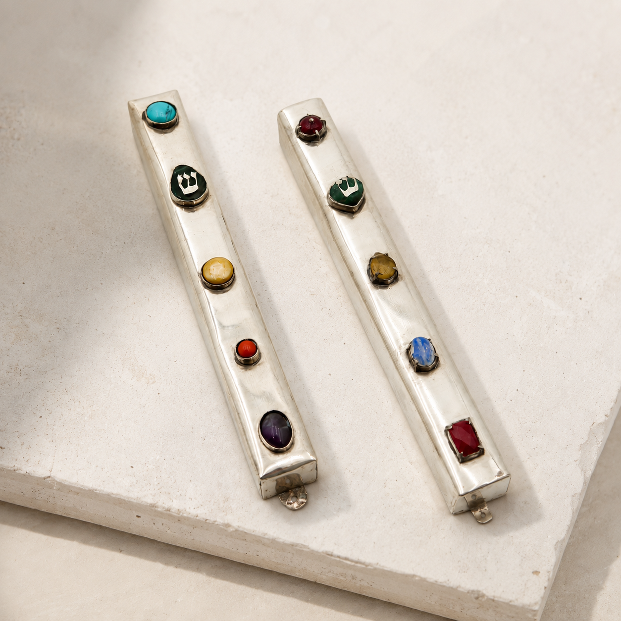 Two silver mezzuzot with real gemstones