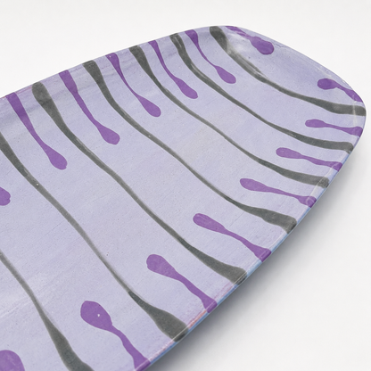 Detail view of Beni oven-safe ceramic serving platter showing purple and gray drip glaze pattern