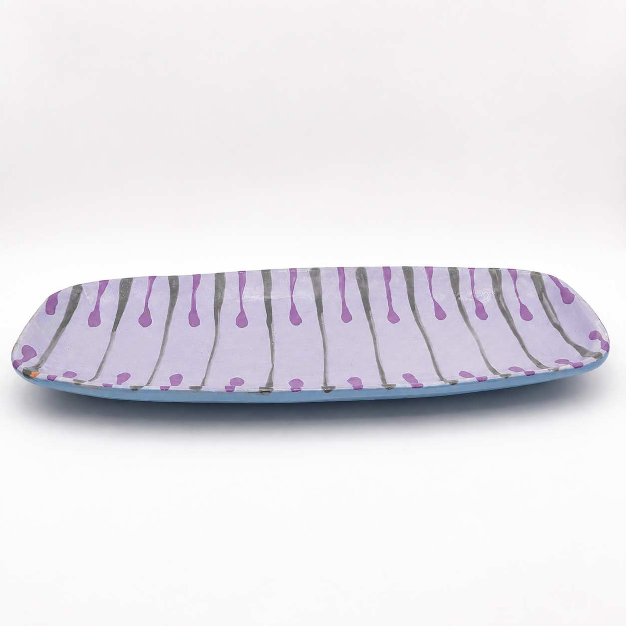 Side view of Beni oven-safe ceramic serving platter showing rectangular shape and light blue base glaze