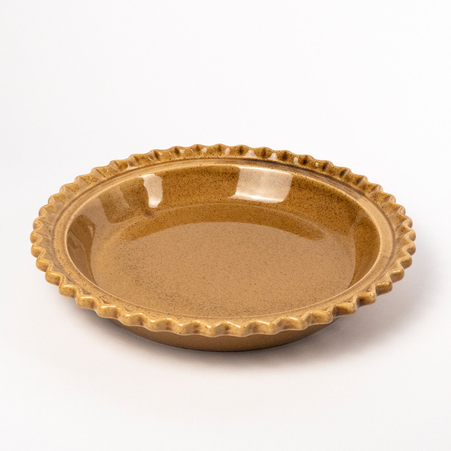 A round ceramic pie dish with a scalloped fluted rim, featuring a speckled metallic gold-brown glaze, photographed on a clean white background.