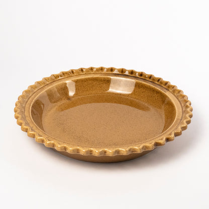 A round ceramic pie dish with a scalloped fluted rim, featuring a speckled metallic gold-brown glaze, photographed on a clean white background.