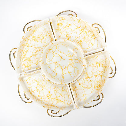 A round ceramic plate with six compartments and a central well, decorated with a gold crackle pattern on a white background, set against a plain white studio backdrop.