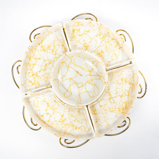 A round ceramic plate with six compartments and a central well, decorated with a gold crackle pattern on a white background, set against a plain white studio backdrop.