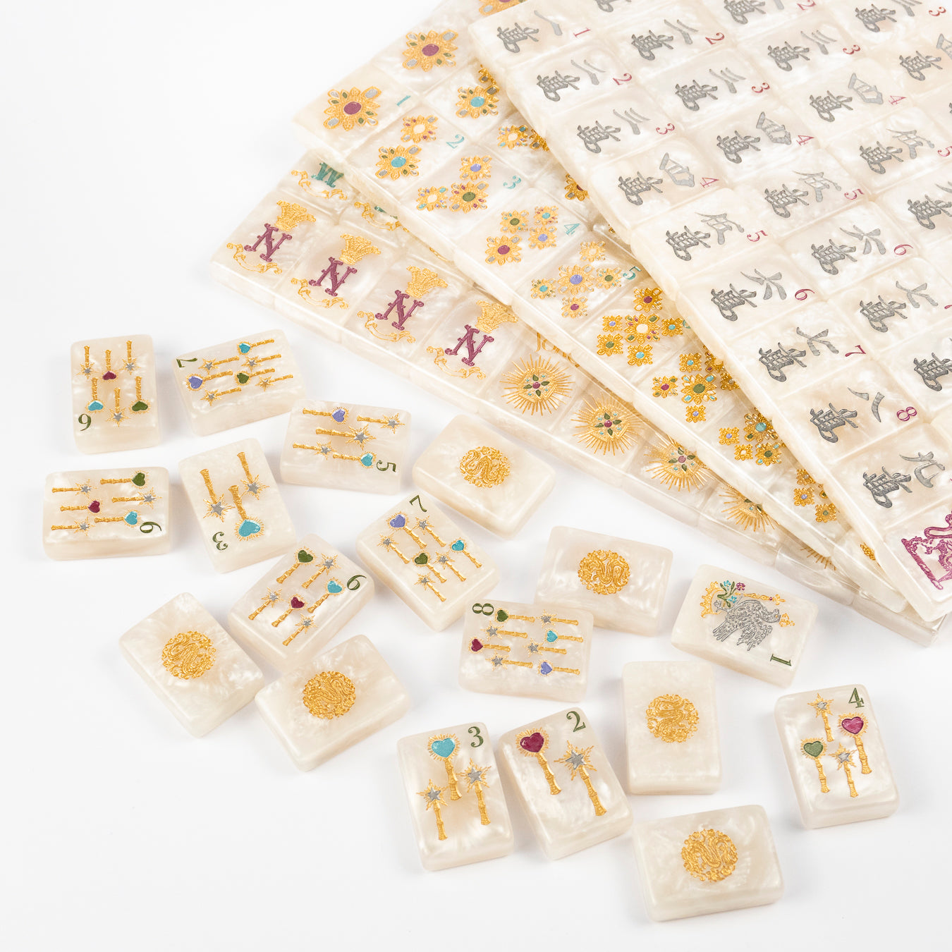 Club Mah Jenn D'or jewel tone mahjong tiles, close detail of hand-painted jewel-tone motifs on white pearl acrylic