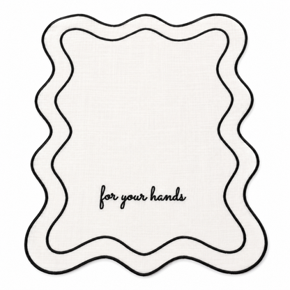 Close up of Elise For Your Hands white cotton guest towels, black script embroidery, scalloped black wave trim, set of two