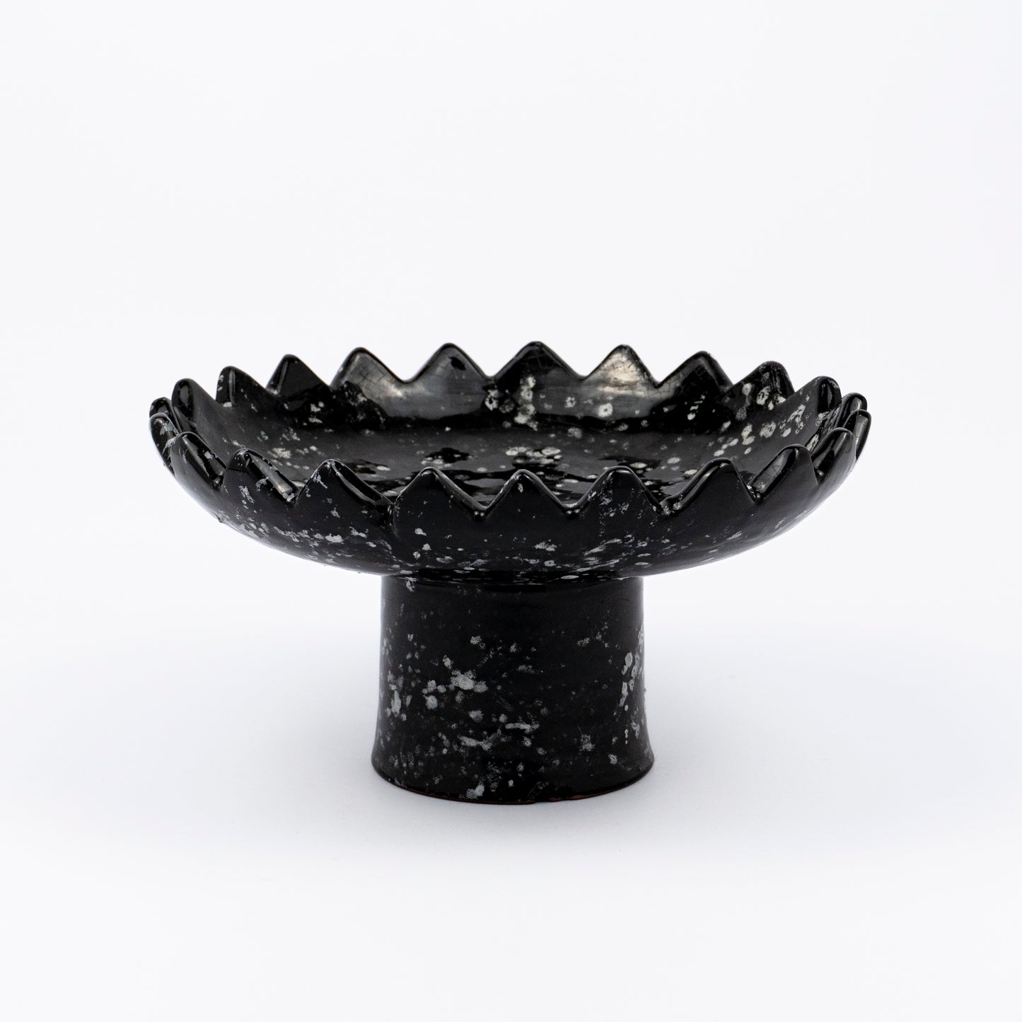Floree ceramic pedestal bowl, black with white speckle glaze, sawtooth zigzag rim, footed base