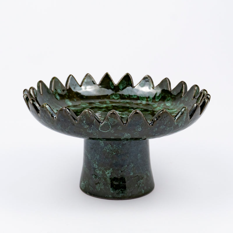 Floree ceramic pedestal bowl, deep green with black speckle glaze, sawtooth zigzag rim, footed base