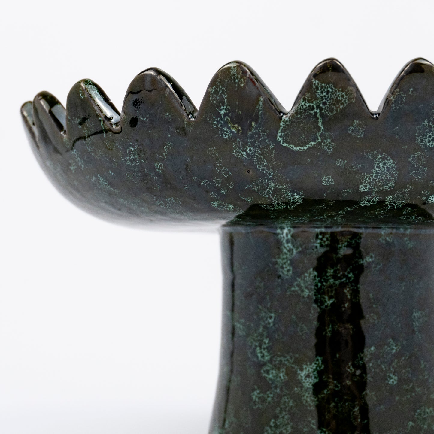 Floree ceramic pedestal bowl, deep green with black speckle glaze, sawtooth zigzag rim, footed base