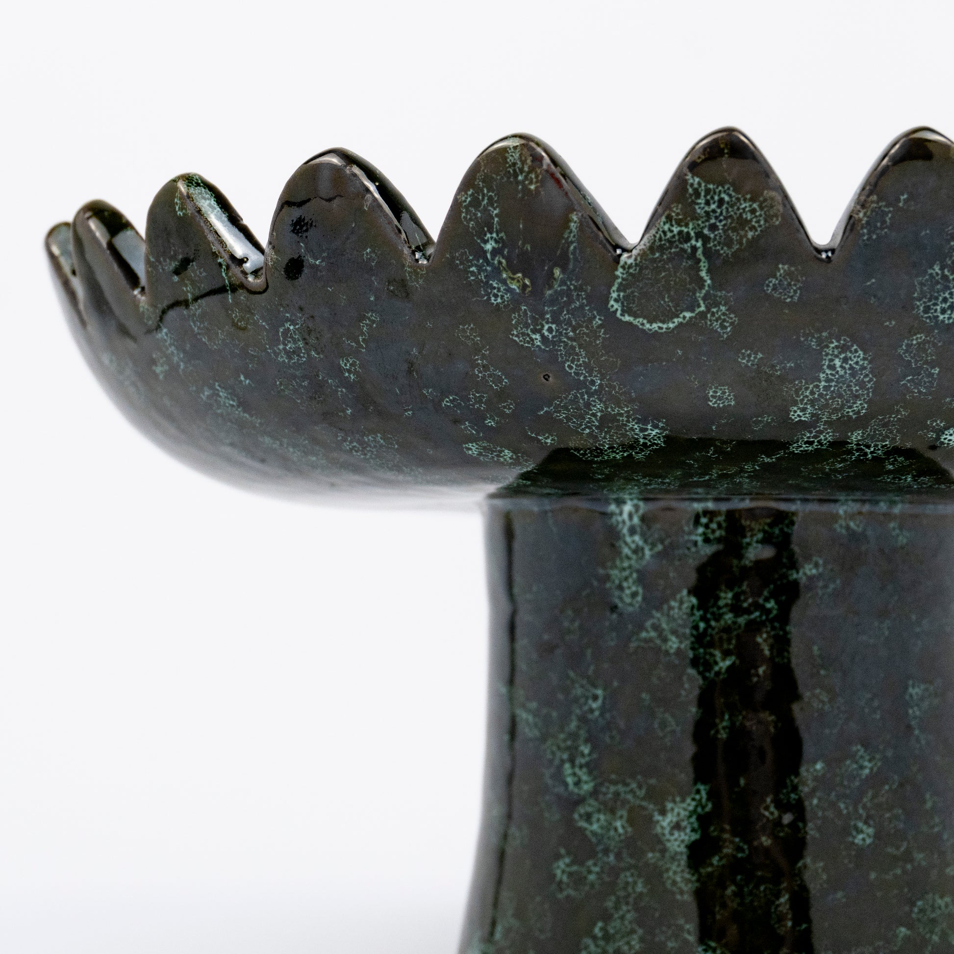 Floree ceramic pedestal bowl, deep green with black speckle glaze, sawtooth zigzag rim, footed base