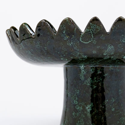 Floree ceramic pedestal bowl, deep green with black speckle glaze, sawtooth zigzag rim, footed base