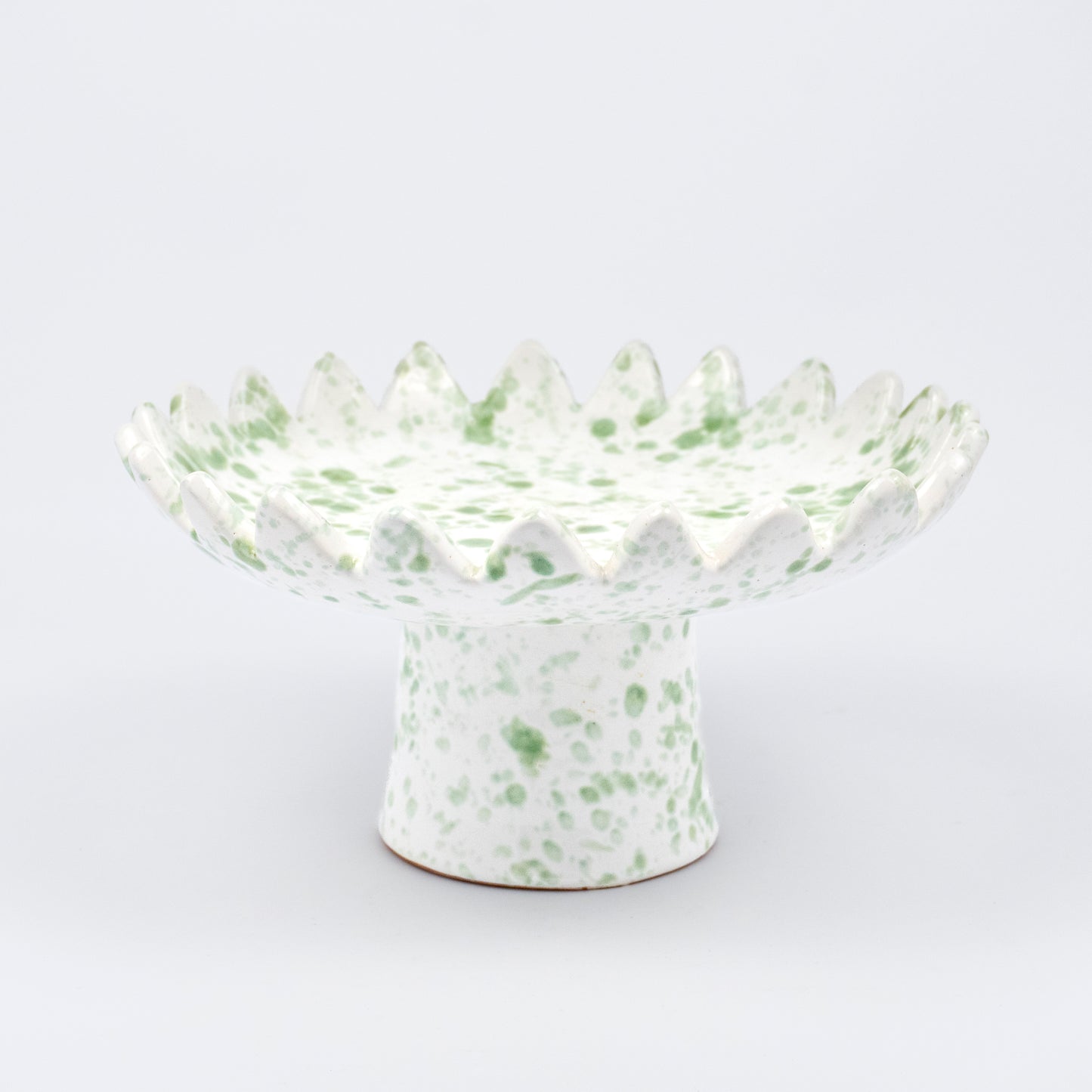 Floree ceramic pedestal bowl, white with light green speckle glaze, sawtooth zigzag rim, footed base