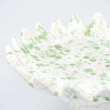 Floree ceramic pedestal bowl, white with light green speckle glaze, sawtooth zigzag rim, footed base