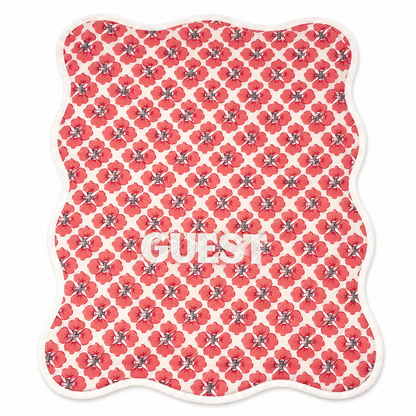 Close up of Geo Guest red poppy block-print hand towels, white GUEST embroidery, terry lined, set of two