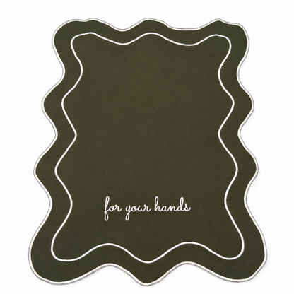 Close up of Hunter For Your Hands olive green guest towels, white script embroidery, scalloped wave trim, set of two