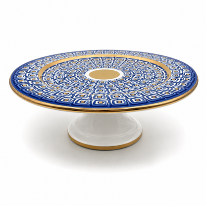 Nico Maiolica ceramic cake stand on pedestal base, navy blue geometric pattern with gold rim and center medallion