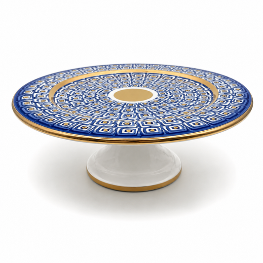 Nico Maiolica ceramic cake stand on pedestal base, navy blue geometric pattern with gold rim and center medallion