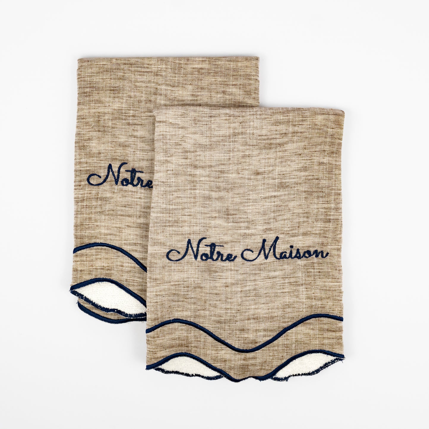 Nino Notre Maison natural linen guest towels, navy script embroidery, scalloped navy wave trim, set of two