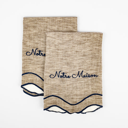 Nino Notre Maison natural linen guest towels, navy script embroidery, scalloped navy wave trim, set of two