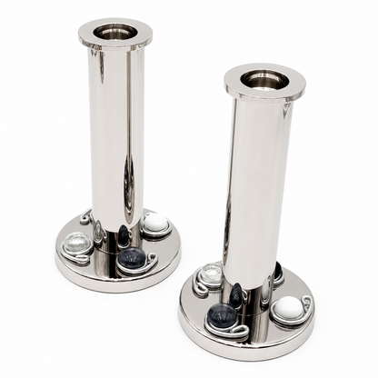 Two polished silver candlestick holders with black and white gemstones 