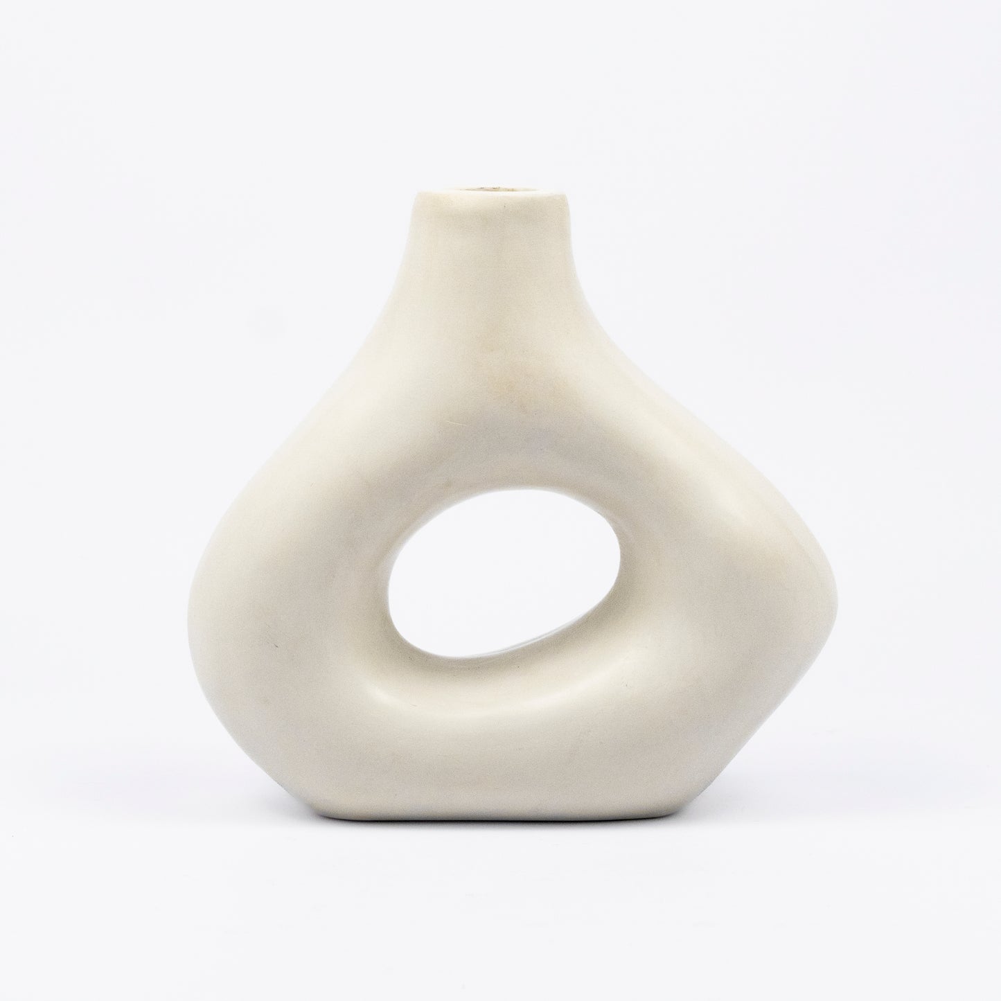 Cream ceramic vase, organic asymmetric form with open cutout center, matte finish, narrow spout