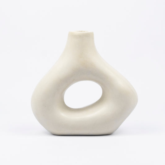 Cream ceramic vase, organic asymmetric form with open cutout center, matte finish, narrow spout