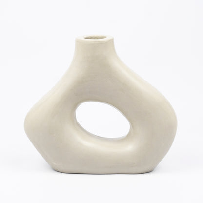 Cream ceramic vase, organic asymmetric form with open cutout center, matte finish, narrow spout