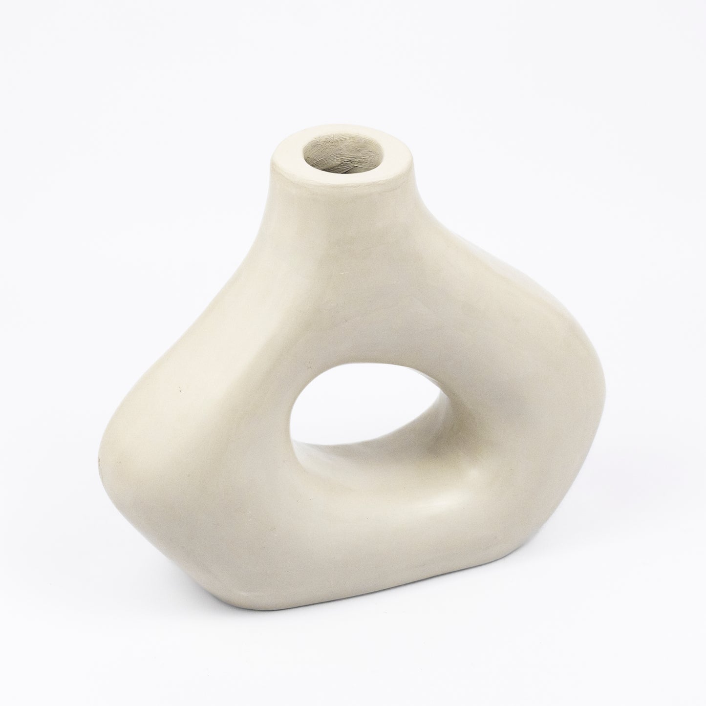 Cream ceramic vase, organic asymmetric form with open cutout center, matte finish, narrow spout