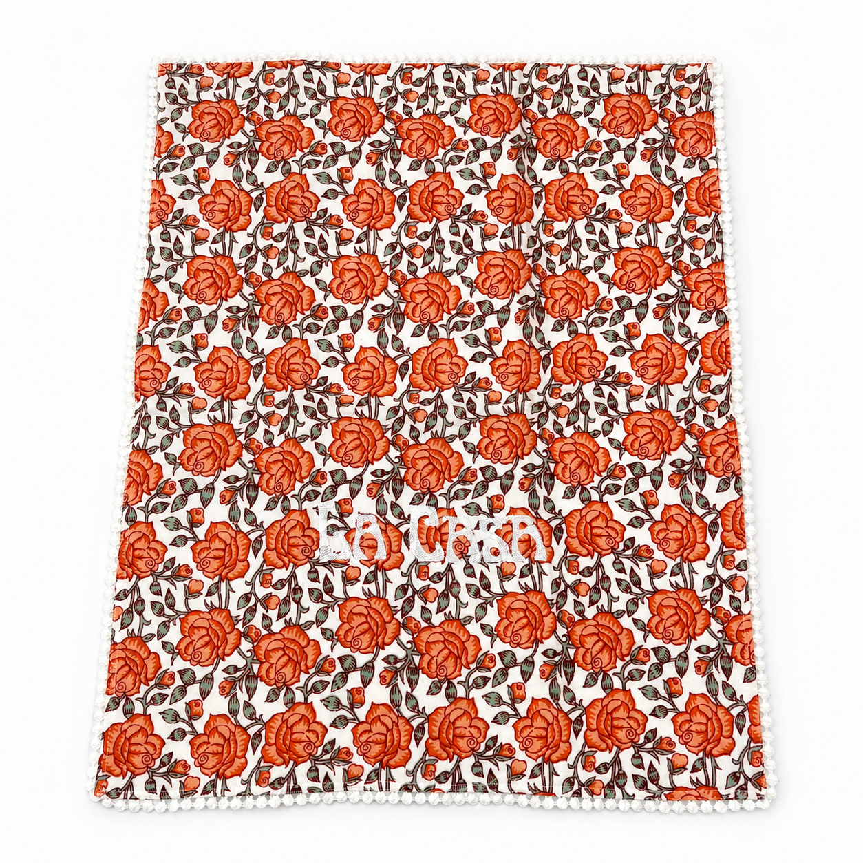 Close up of Orly La Casa coral rose floral guest towels, white LA CASA embroidery, pom-pom trim, set of two