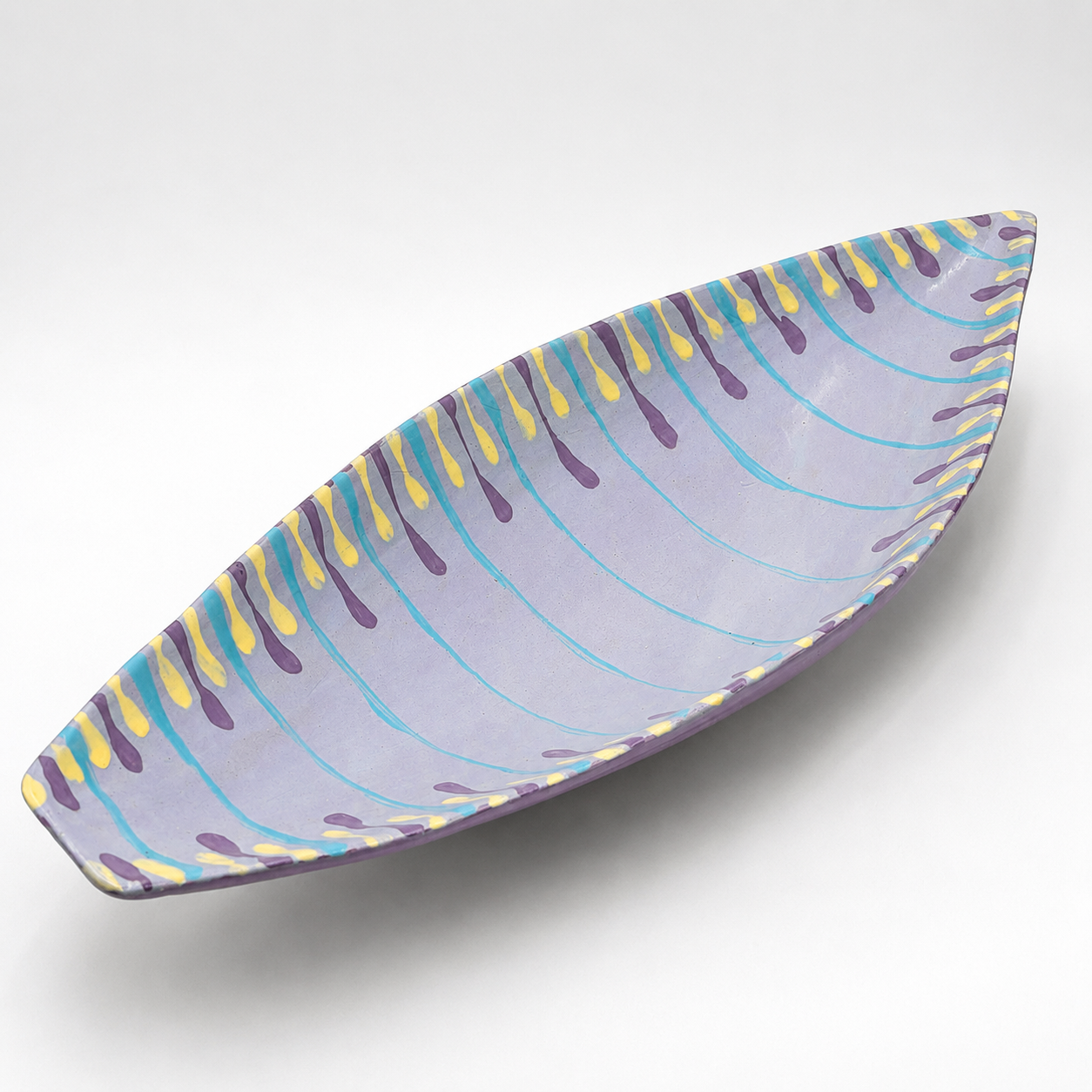 Santino oven-safe ceramic serving bowl, boat shape in lavender with hand-painted teal, purple, and yellow drip pattern