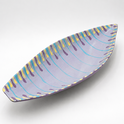 Santino oven-safe ceramic serving bowl, boat shape in lavender with hand-painted teal, purple, and yellow drip pattern