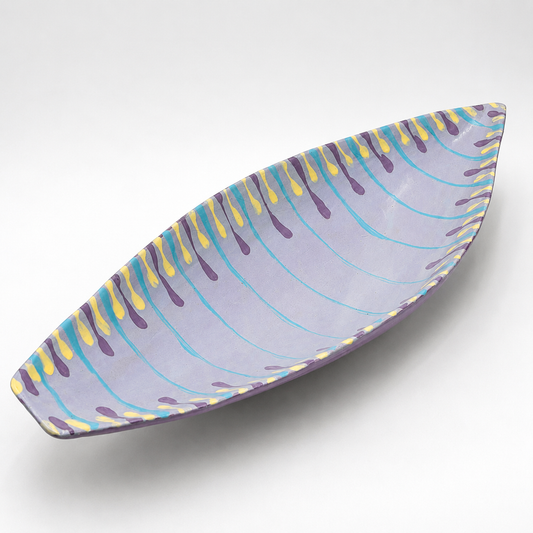 Santino oven-safe ceramic serving bowl, boat shape in lavender with hand-painted teal, purple, and yellow drip pattern
