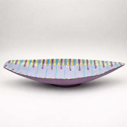 Side view of Santino oven-safe ceramic serving bowl showing elongated boat shape and purple glaze exterior