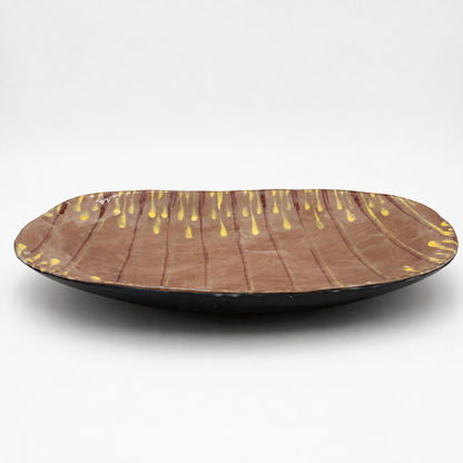 Side view of Taro oven-safe ceramic serving bowl showing dark exterior glaze and shallow oval profile